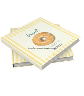 An interior view of the opened booklet, showcasing the lay-flat capability of the thread-sewn binding, detailed food photography, and crisp printed menu text