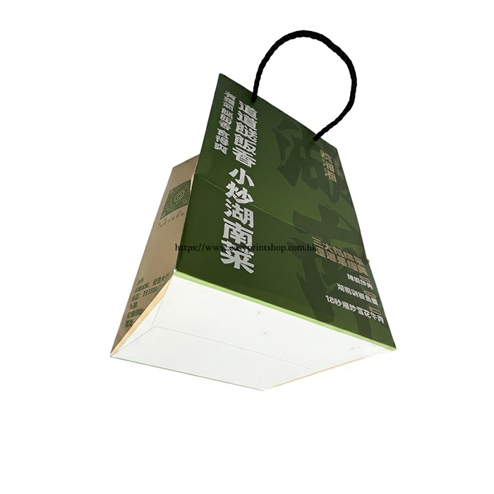 High-angle view of the green paper bag, showcasing the top edge and handle printing details High-angle view of the green paper bag, showcasing the top edge and handle printing details