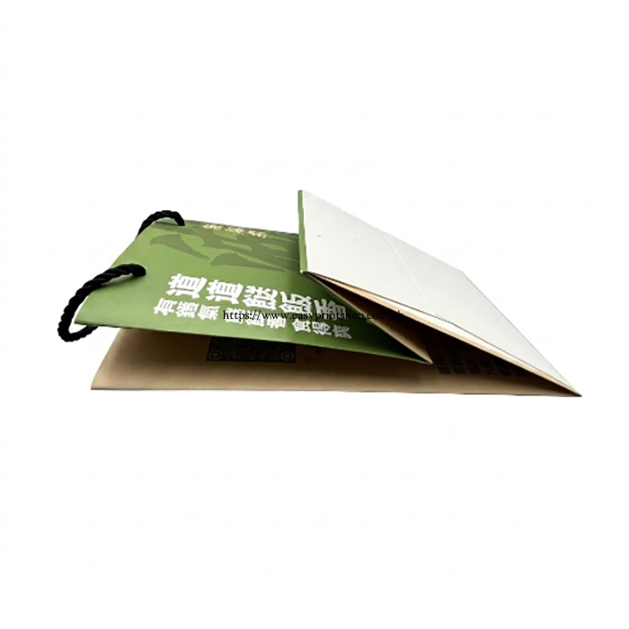 The green paper bag shown completely folded flat, revealing the printed surface details The green paper bag shown completely folded flat, revealing the printed surface details