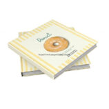 An interior view of the opened booklet, showcasing the lay-flat capability of the thread-sewn binding, detailed food photography, and crisp printed menu text